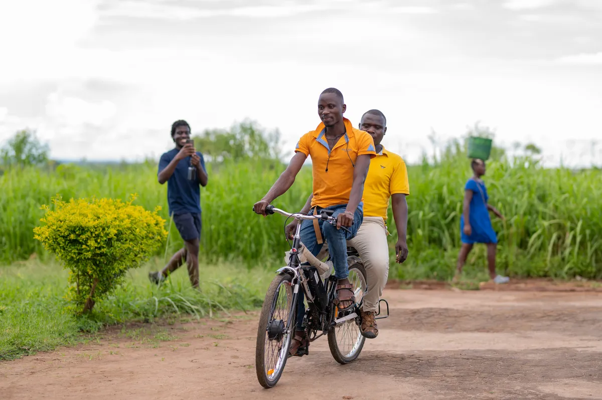 An electric bicycle charged from the mini grid in use on a village road